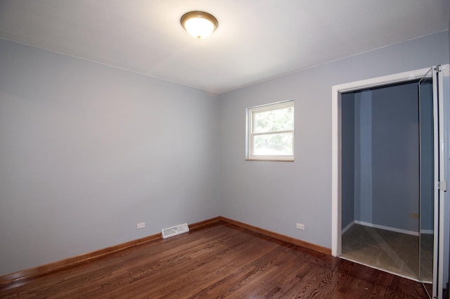 1033 S Main Dr, Lombard, IL 60148 - unfurnished bedroom featuring dark wood-style flooring and baseboards