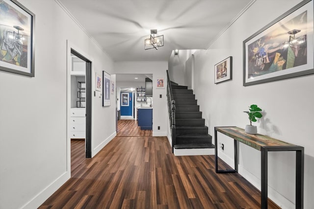2620 Vermont St, Blue Island, IL 60406 - hallway featuring crown molding, stairway, dark wood-style floors, and a chandelier