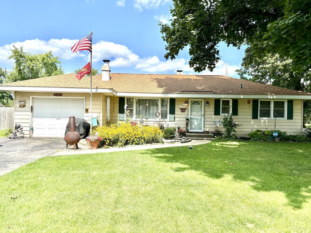 3115 September Dr, Joliet, IL 60431 - ranch-style home featuring a garage, a front lawn, concrete driveway, and a chimney