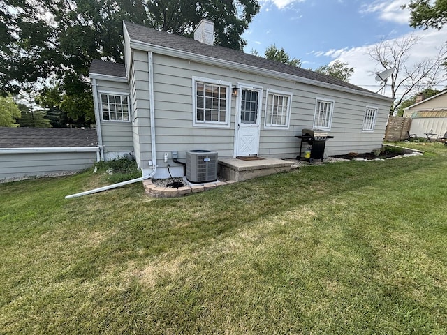 1805 Rock St, Peru, IL 61354 - back of house with a lawn, a chimney, and a shingled roof