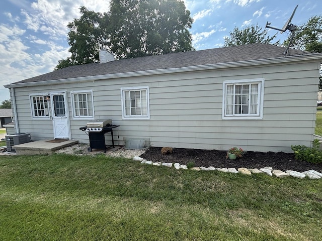 1805 Rock St, Peru, IL 61354 - back of house with a lawn, a chimney, and a shingled roof
