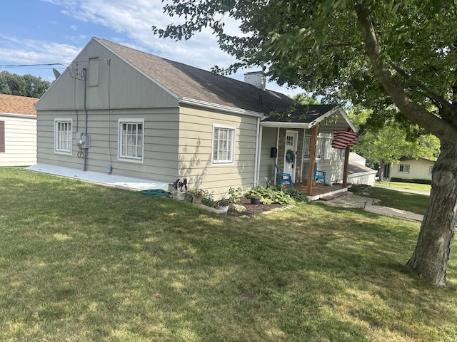 1805 Rock St, Peru, IL 61354 - back of property with a yard, a chimney, and a shingled roof