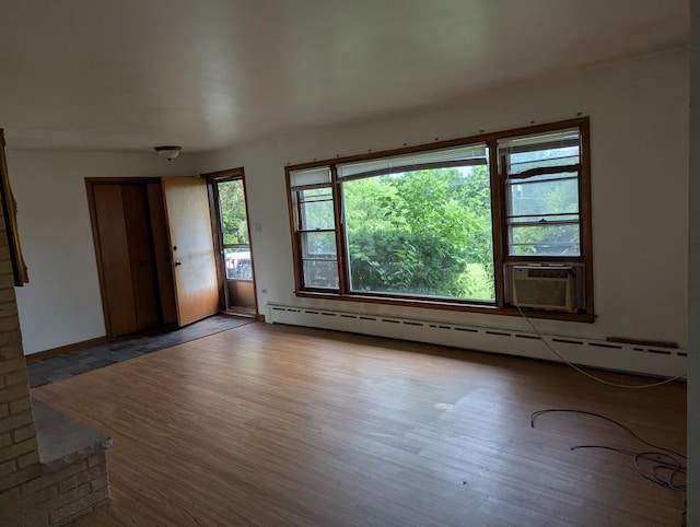 219 W 79th St, Burr Ridge, IL 60527 - empty room featuring baseboard heating, wood finished floors, and cooling unit