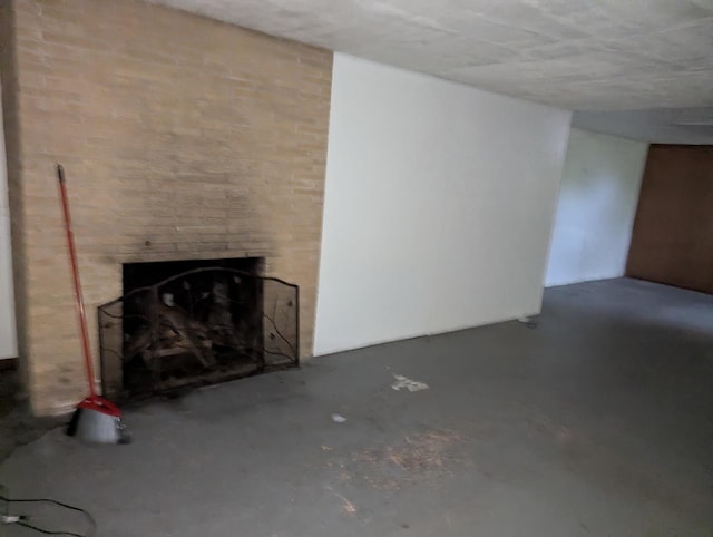 219 W 79th St, Burr Ridge, IL 60527 - unfurnished living room featuring concrete flooring and a fireplace