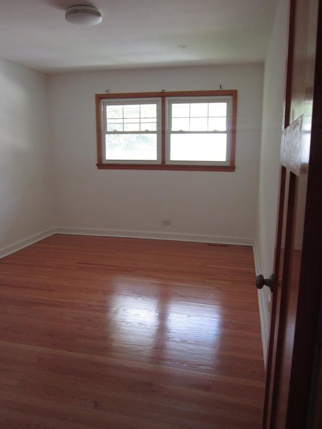 15831 Trumbull Ave, Markham, IL 60428 - unfurnished room featuring plenty of natural light and wood finished floors