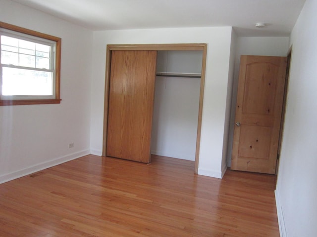 15831 Trumbull Ave, Markham, IL 60428 - unfurnished bedroom with light wood-type flooring and a closet