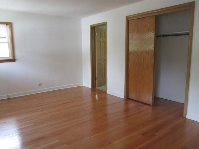 15831 Trumbull Ave, Markham, IL 60428 - unfurnished bedroom featuring light wood finished floors and a closet