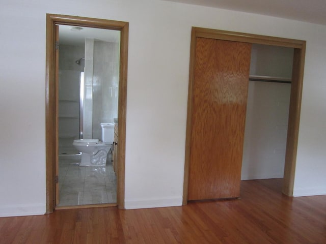 15831 Trumbull Ave, Markham, IL 60428 - unfurnished bedroom with wood finished floors, a closet, and connected bathroom