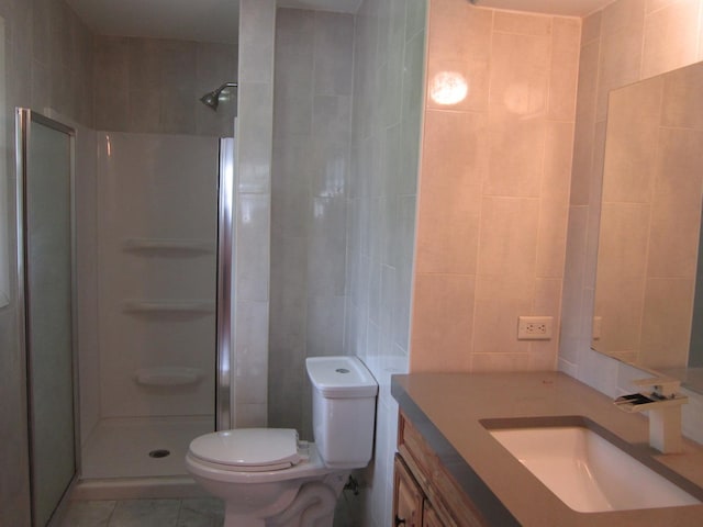 15831 Trumbull Ave, Markham, IL 60428 - bathroom with a shower stall, tile walls, vanity, and tile patterned floors