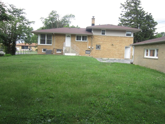 15831 Trumbull Ave, Markham, IL 60428 - rear view of property with a chimney, a lawn, and brick siding