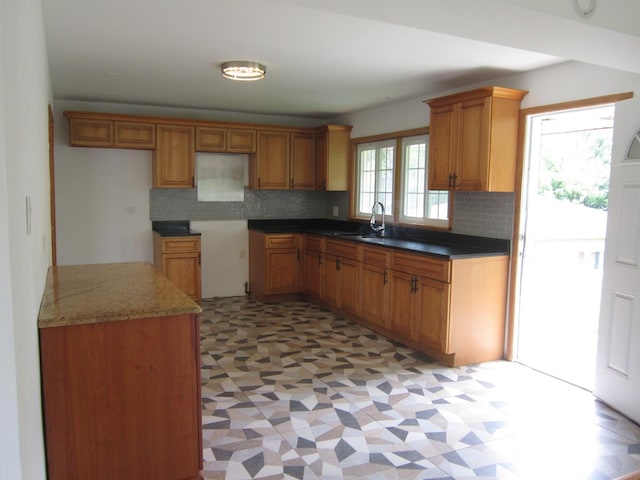 15831 Trumbull Ave, Markham, IL 60428 - kitchen featuring backsplash, light floors, and brown cabinetry