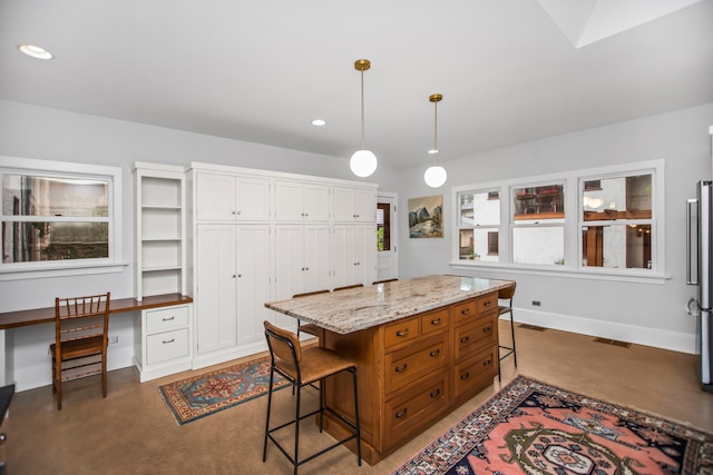 519 N Elmwood Ave, Oak Park, IL 60302 - kitchen with a kitchen bar, light stone counters, pendant lighting, recessed lighting, and a center island