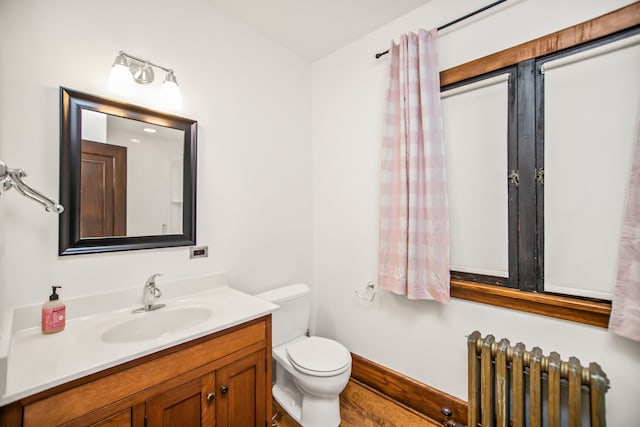 519 N Elmwood Ave, Oak Park, IL 60302 - bathroom featuring radiator heating unit, vanity, and wood finished floors