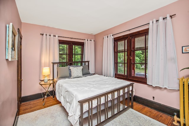 519 N Elmwood Ave, Oak Park, IL 60302 - bedroom with wood finished floors and radiator heating unit