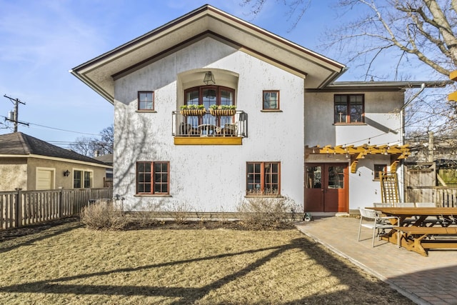 519 N Elmwood Ave, Oak Park, IL 60302 - back of property with a balcony, stucco siding, and a patio area