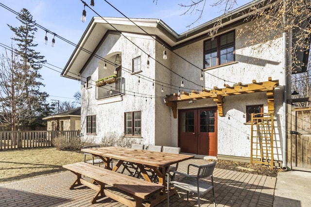 519 N Elmwood Ave, Oak Park, IL 60302 - rear view of house with stucco siding, a patio area, outdoor dining space, and a balcony