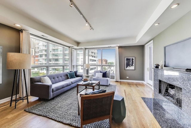 1600 S Wabash Ave Unit 4E, Chicago, IL 60616 - living area featuring track lighting, wood finished floors, a premium fireplace, healthy amount of natural light, and recessed lighting