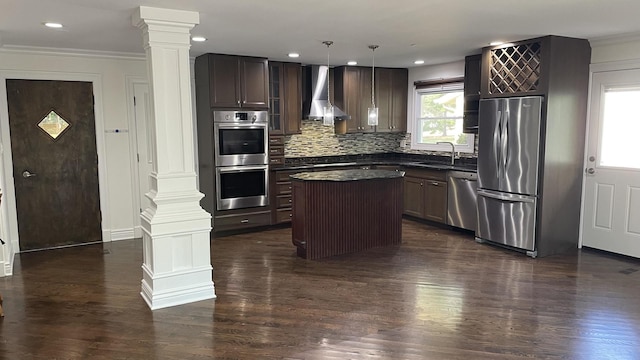 513 Laurel St, Elk Grove Village, IL 60007 - kitchen featuring ornate columns, stainless steel appliances, wall chimney exhaust hood, dark countertops, and ornamental molding