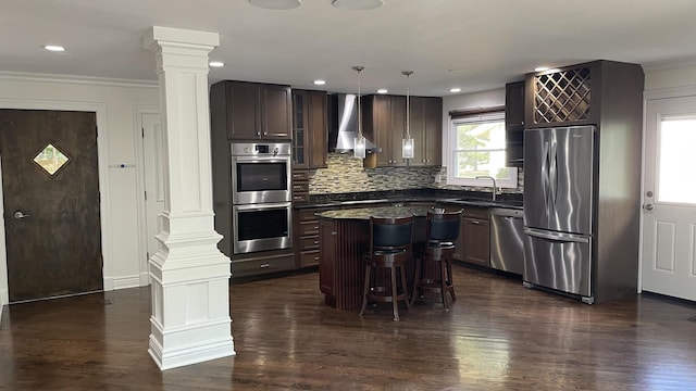 513 Laurel St, Elk Grove Village, IL 60007 - kitchen featuring decorative columns, appliances with stainless steel finishes, wall chimney range hood, dark countertops, and ornamental molding