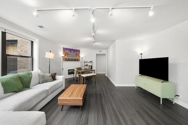 7409 N Seeley Ave Unit 2B, Chicago, IL 60645 - living room with rail lighting, a fireplace, and wood finished floors