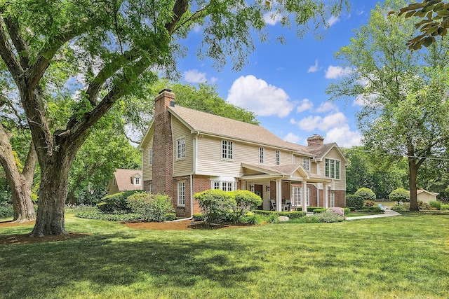 15606 W Sweedler Rd, Manhattan, IL 60442 - view of front of home with a chimney, brick siding, and a front lawn