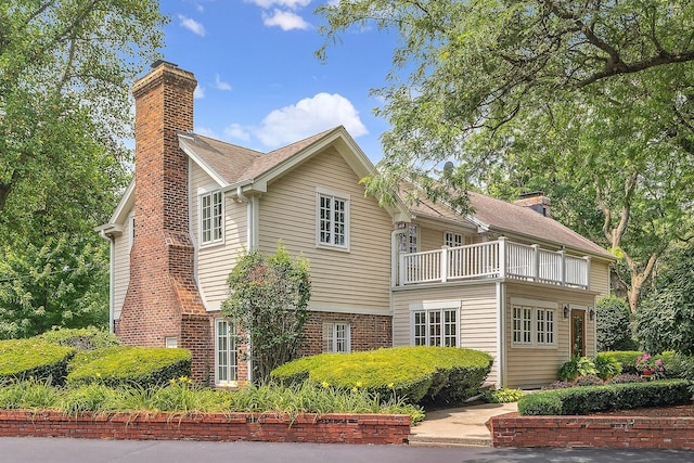 15606 W Sweedler Rd, Manhattan, IL 60442 - view of home's exterior featuring a chimney, a balcony, and brick siding