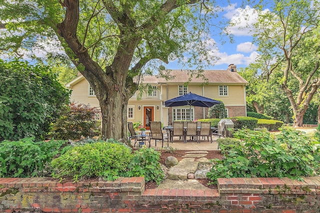 15606 W Sweedler Rd, Manhattan, IL 60442 - rear view of house with a patio area, a chimney, and brick siding