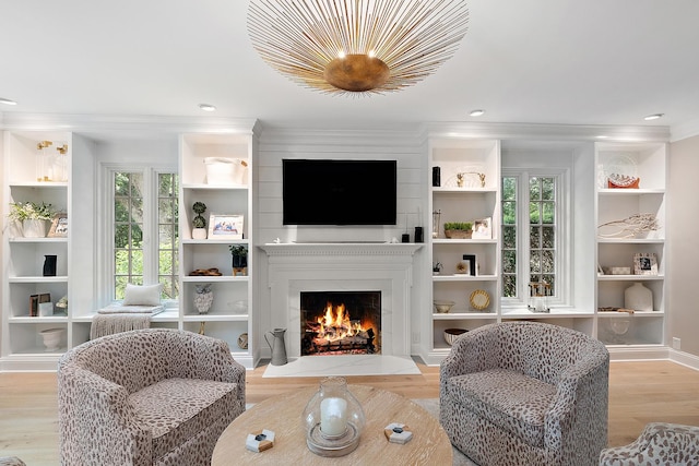 15606 W Sweedler Rd, Manhattan, IL 60442 - living room featuring wood finished floors, a lit fireplace, crown molding, built in features, and recessed lighting