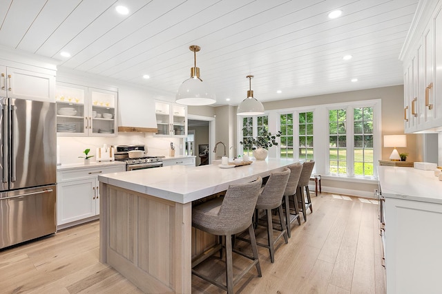 15606 W Sweedler Rd, Manhattan, IL 60442 - kitchen with stainless steel appliances, recessed lighting, light wood-style floors, a center island with sink, and white cabinets