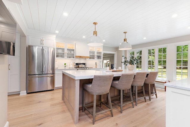 15606 W Sweedler Rd, Manhattan, IL 60442 - kitchen featuring appliances with stainless steel finishes, wood ceiling, light wood finished floors, a kitchen island with sink, and light countertops