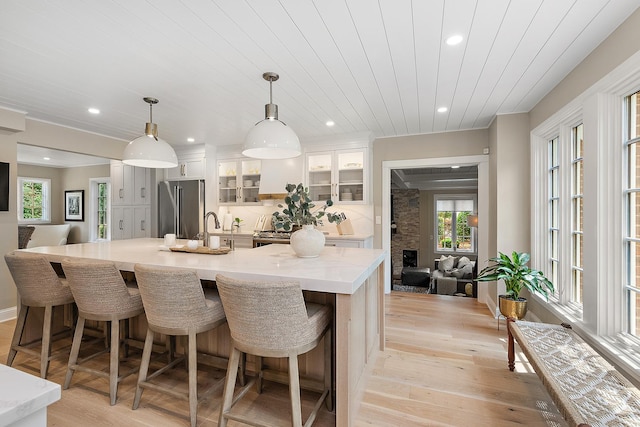 15606 W Sweedler Rd, Manhattan, IL 60442 - kitchen with high end fridge, light wood-style floors, light countertops, a large island, and recessed lighting