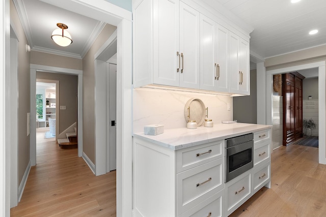 15606 W Sweedler Rd, Manhattan, IL 60442 - kitchen with stainless steel microwave, ornamental molding, light wood-style floors, white cabinetry, and recessed lighting