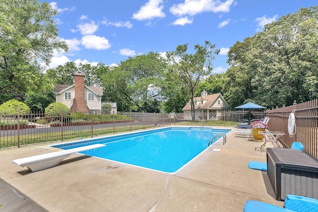 15606 W Sweedler Rd, Manhattan, IL 60442 - view of swimming pool with a patio area, a diving board, a fenced backyard, and view of scattered trees