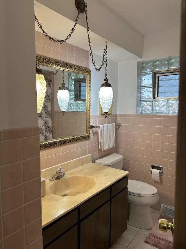 9362 Clancy Dr, Des Plaines, IL 60016 - bathroom featuring tile walls, tile patterned flooring, vanity, and a shower with curtain