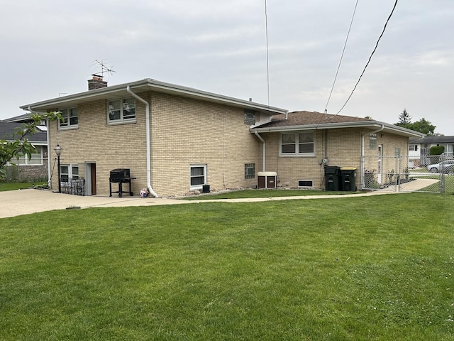 9362 Clancy Dr, Des Plaines, IL 60016 - rear view of house featuring brick siding, a chimney, and a patio area