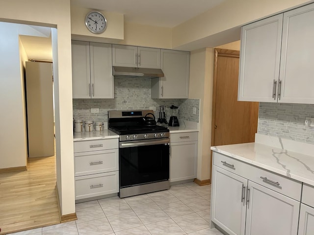 9362 Clancy Dr, Des Plaines, IL 60016 - kitchen featuring stainless steel range, under cabinet range hood, gray cabinets, and tasteful backsplash