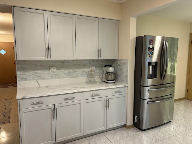 9362 Clancy Dr, Des Plaines, IL 60016 - kitchen with stainless steel fridge with ice dispenser, gray cabinetry, backsplash, light stone counters, and light tile patterned floors