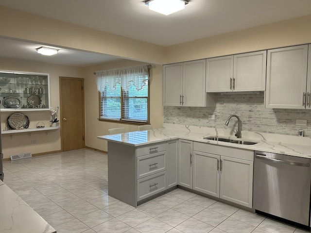9362 Clancy Dr, Des Plaines, IL 60016 - kitchen featuring stainless steel dishwasher, gray cabinetry, a peninsula, light stone counters, and decorative backsplash