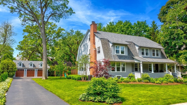 330 Abbotsford Rd, Kenilworth, IL 60043 - shingle-style home with a garage, covered porch, a front yard, an outdoor structure, and a chimney