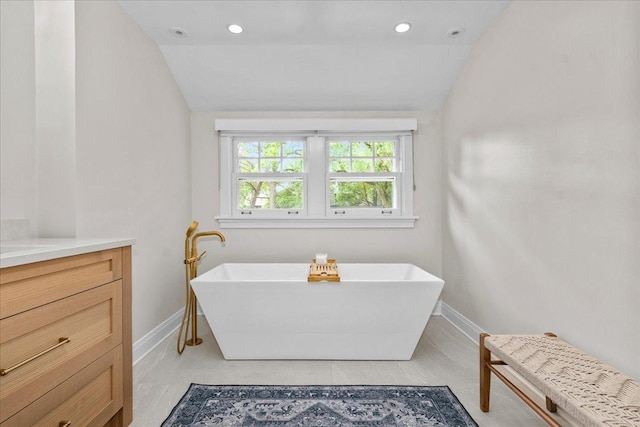 330 Abbotsford Rd, Kenilworth, IL 60043 - bathroom with lofted ceiling, a freestanding bath, vanity, and recessed lighting