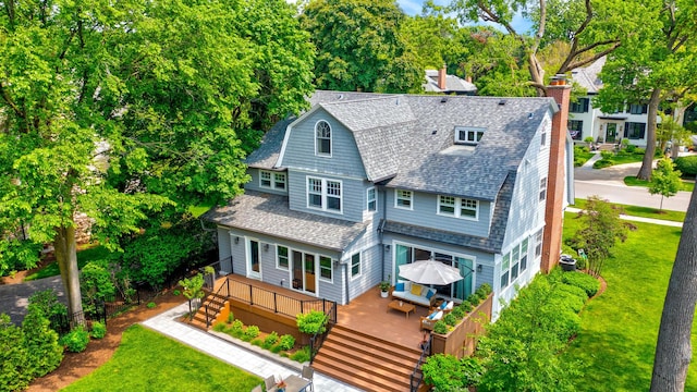 330 Abbotsford Rd, Kenilworth, IL 60043 - rear view of house featuring roof with shingles, a wooden deck, a lawn, a chimney, and stairs