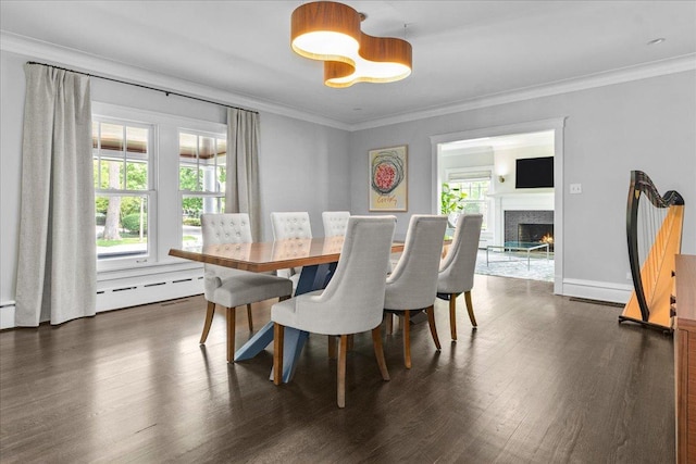 330 Abbotsford Rd, Kenilworth, IL 60043 - dining space with dark wood-style flooring, ornamental molding, a warm lit fireplace, and baseboard heating