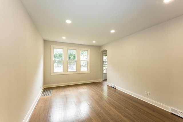 10940 S Trumbull Ave, Chicago, IL 60655 - unfurnished room with arched walkways, recessed lighting, and dark wood-style floors