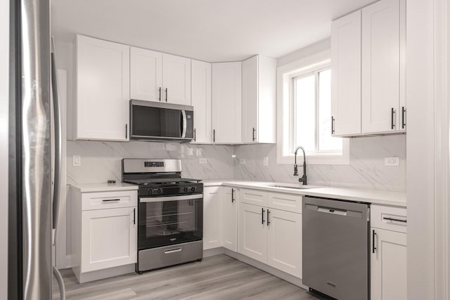 10940 S Trumbull Ave, Chicago, IL 60655 - kitchen featuring stainless steel appliances, light countertops, decorative backsplash, and white cabinets