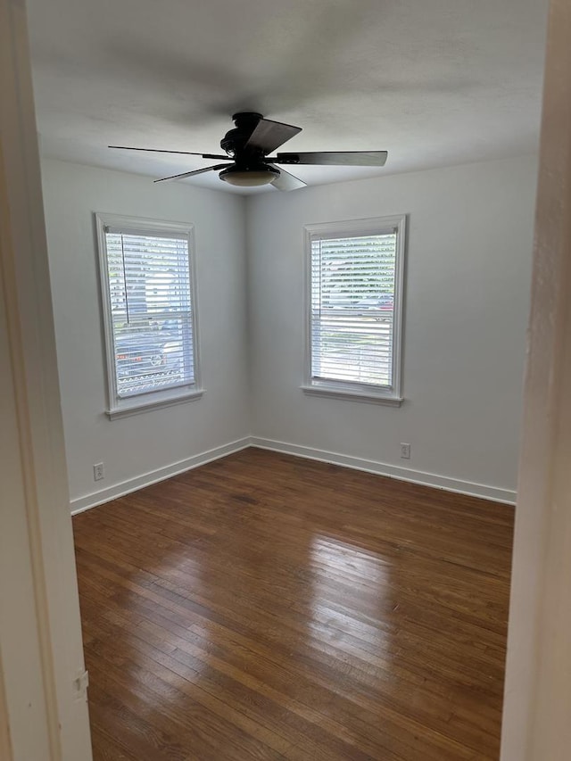 925 E Sangamon Ave, Rantoul, IL 61866 - empty room featuring plenty of natural light, dark wood-style flooring, and ceiling fan
