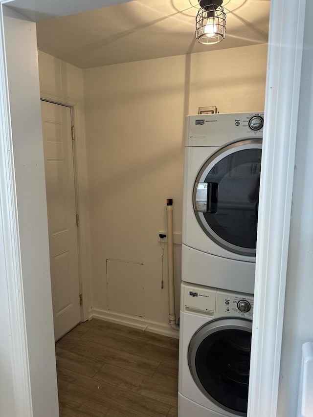925 E Sangamon Ave, Rantoul, IL 61866 - washroom featuring stacked washing machine and dryer and wood finished floors