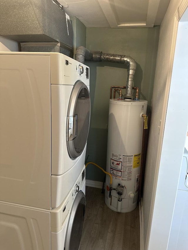 925 E Sangamon Ave, Rantoul, IL 61866 - laundry room with gas water heater, estacked washer and dryer, and dark wood-style floors