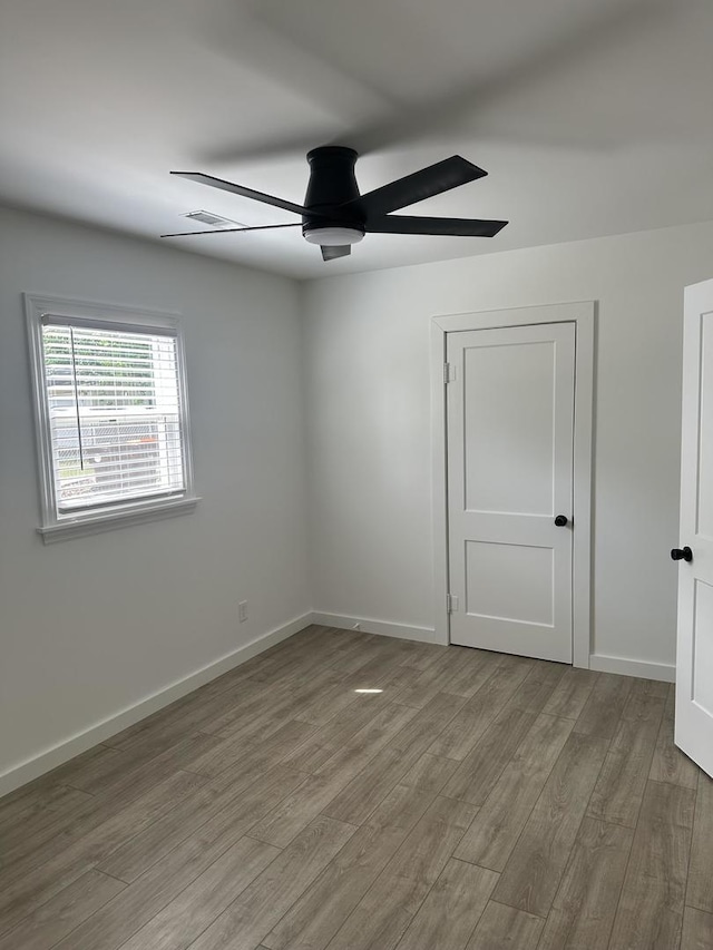 925 E Sangamon Ave, Rantoul, IL 61866 - spare room featuring a ceiling fan and wood finished floors
