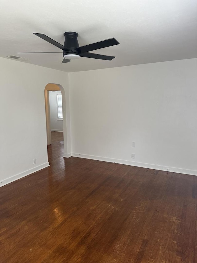 925 E Sangamon Ave, Rantoul, IL 61866 - spare room with a ceiling fan, arched walkways, and dark wood-style flooring