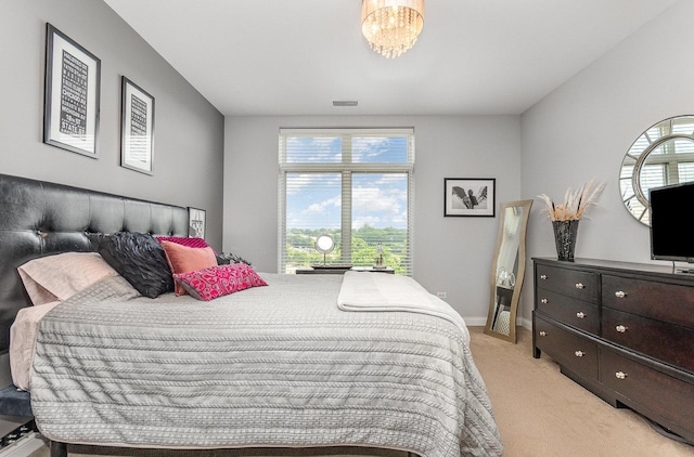 140 S River St Unit 307, Aurora, IL 60506 - bedroom featuring light colored carpet and a chandelier